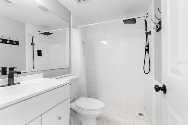 bathroom featuring curtained shower, vanity, and toilet