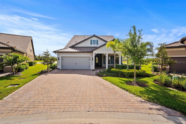 view of front of home with a garage and a front lawn