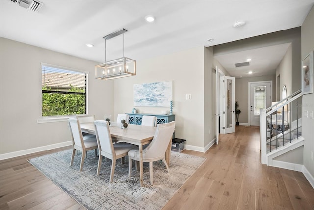 dining room featuring light hardwood / wood-style floors and a notable chandelier