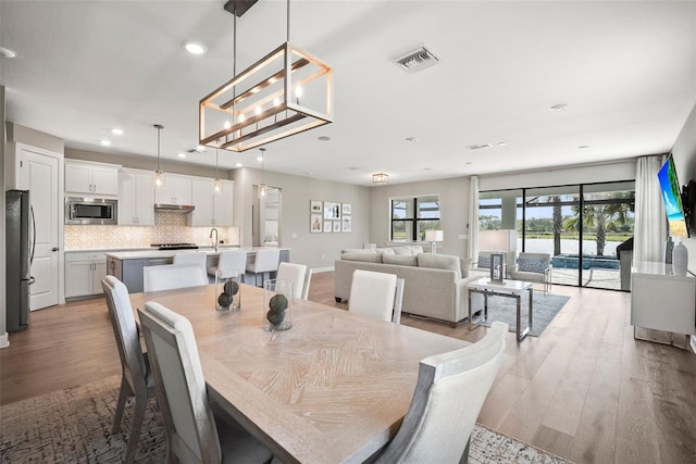 dining room with sink and light hardwood / wood-style floors