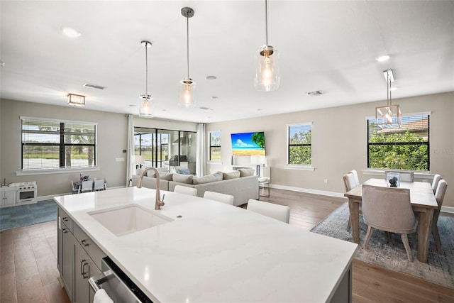 kitchen featuring dark hardwood / wood-style flooring, decorative light fixtures, and sink