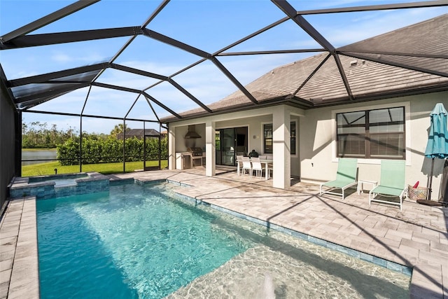 view of swimming pool with a patio, a lanai, and area for grilling