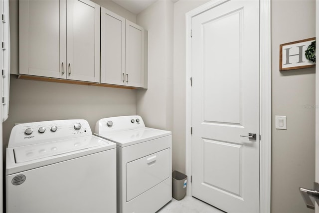 laundry room with cabinets and separate washer and dryer