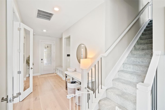 foyer entrance with light hardwood / wood-style flooring