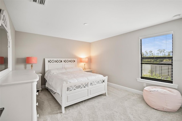 bedroom featuring light carpet