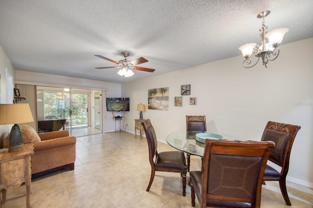 dining area featuring ceiling fan with notable chandelier, a textured ceiling, and light tile floors