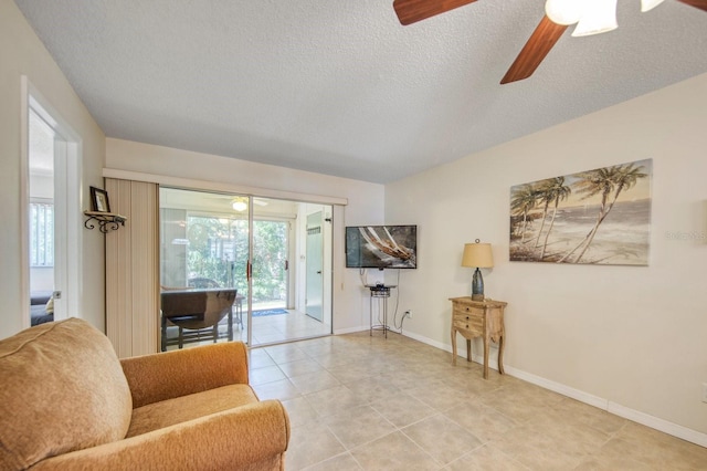 interior space with ceiling fan and a textured ceiling