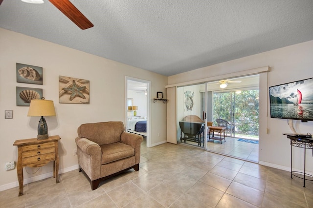 sitting room featuring a textured ceiling, ceiling fan, and light tile floors