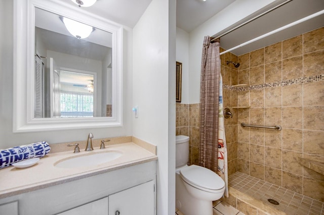 bathroom featuring curtained shower, vanity, and toilet