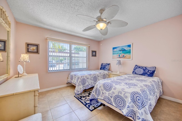 bedroom featuring ceiling fan, a textured ceiling, and light tile flooring