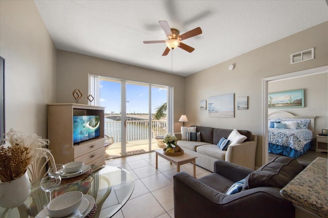 living room featuring ceiling fan and light tile patterned flooring