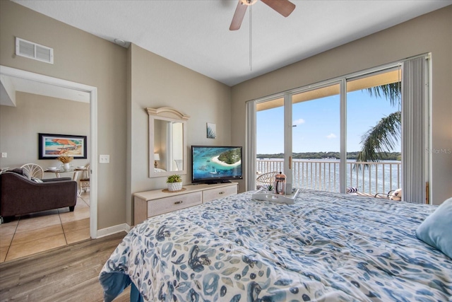 bedroom with access to outside, light hardwood / wood-style flooring, and ceiling fan