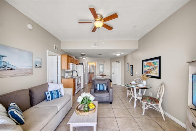 living room featuring light tile patterned floors and ceiling fan