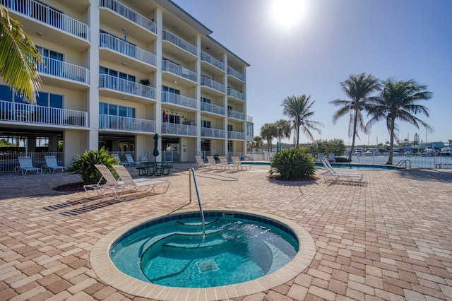 view of pool with a community hot tub