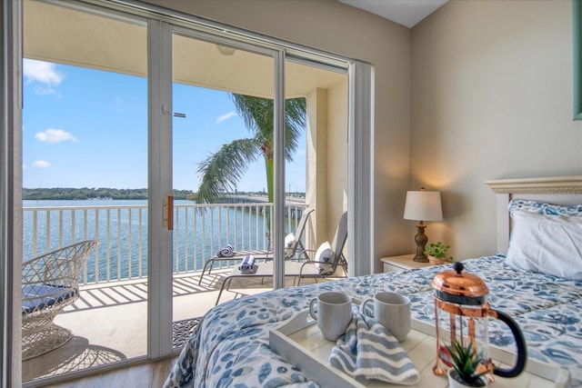 bedroom featuring access to exterior and a water view