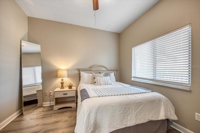 bedroom with ceiling fan and light wood-type flooring