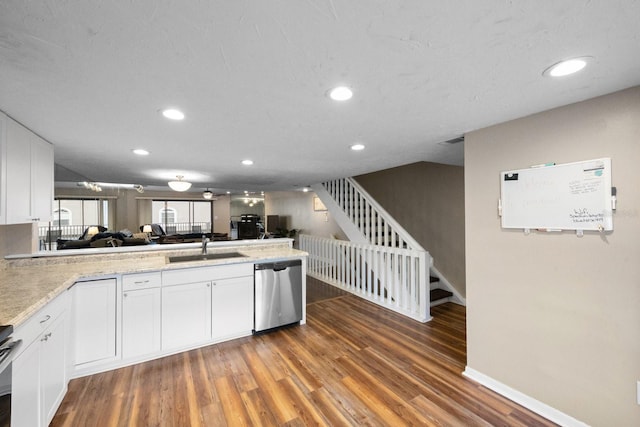 kitchen with dark hardwood / wood-style floors, sink, white cabinetry, and stainless steel dishwasher