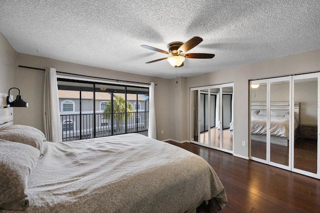 bedroom featuring two closets, ceiling fan, a textured ceiling, access to exterior, and dark hardwood / wood-style floors