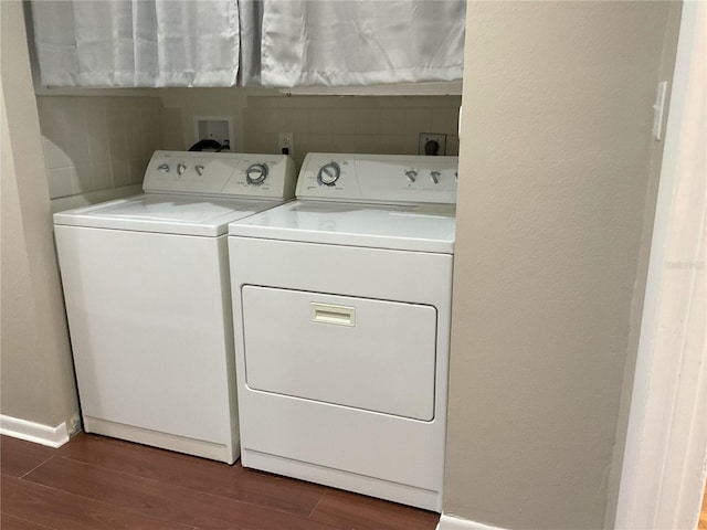 laundry area featuring dark hardwood / wood-style floors, hookup for an electric dryer, and washing machine and dryer