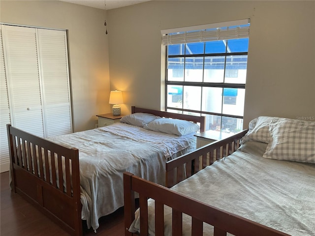 bedroom with a closet and dark hardwood / wood-style floors