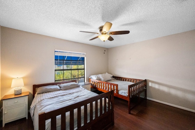 bedroom featuring ceiling fan, dark hardwood / wood-style flooring, and a textured ceiling