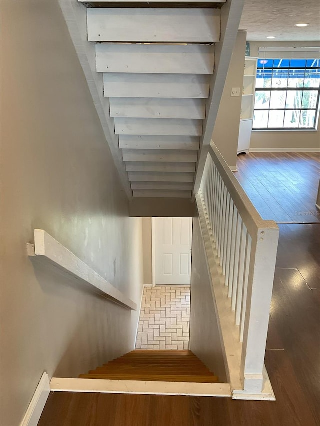 stairs featuring dark hardwood / wood-style flooring