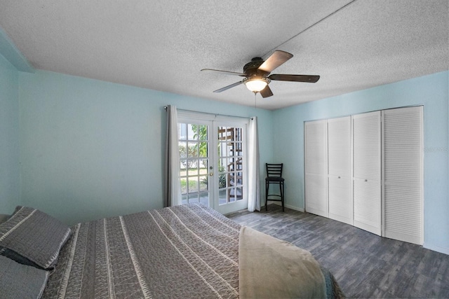 unfurnished bedroom with a closet, ceiling fan, a textured ceiling, dark hardwood / wood-style flooring, and french doors