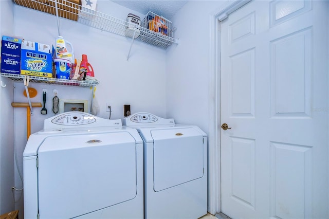 laundry area with hookup for an electric dryer, washing machine and dryer, washer hookup, and a textured ceiling