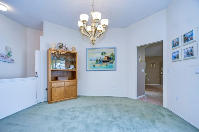 interior space featuring light colored carpet and a notable chandelier