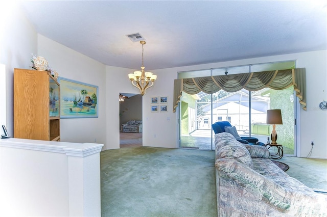 carpeted living room with a chandelier