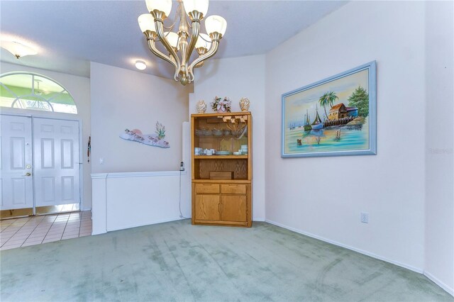 unfurnished dining area featuring light colored carpet and a notable chandelier