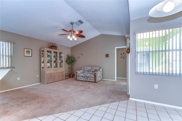 unfurnished room with light carpet, ceiling fan, a textured ceiling, and lofted ceiling