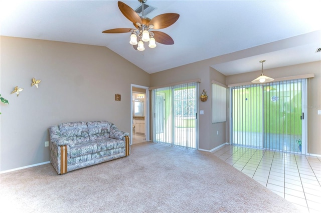 living area featuring light colored carpet, vaulted ceiling, and ceiling fan