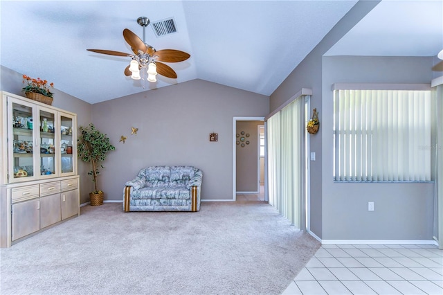 interior space featuring vaulted ceiling, ceiling fan, and light tile flooring