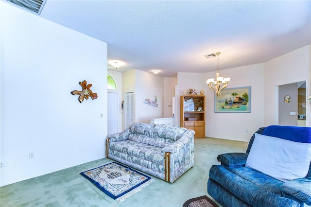 living room with light carpet and an inviting chandelier