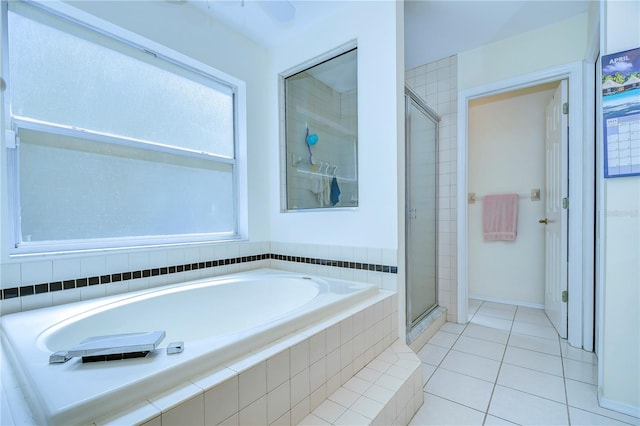 bathroom featuring independent shower and bath and tile flooring