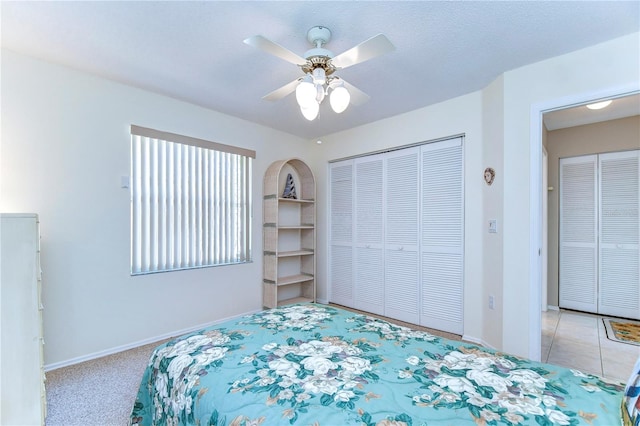 bedroom with light colored carpet, ceiling fan, and a closet