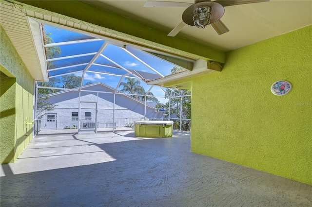 unfurnished sunroom with ceiling fan