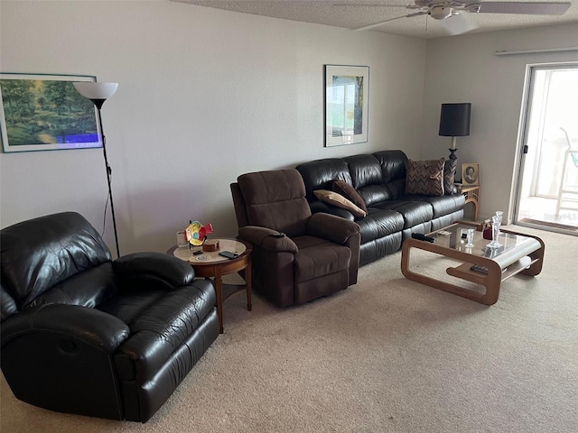 carpeted living room with a textured ceiling and ceiling fan