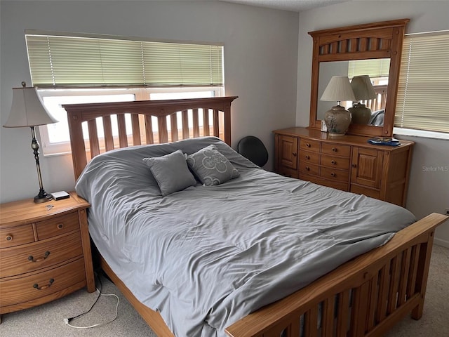 carpeted bedroom with multiple windows