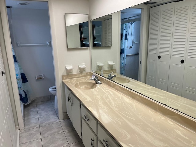 bathroom featuring tile floors, toilet, and vanity