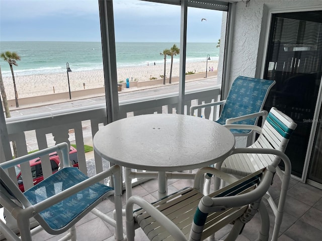 balcony with a beach view and a water view