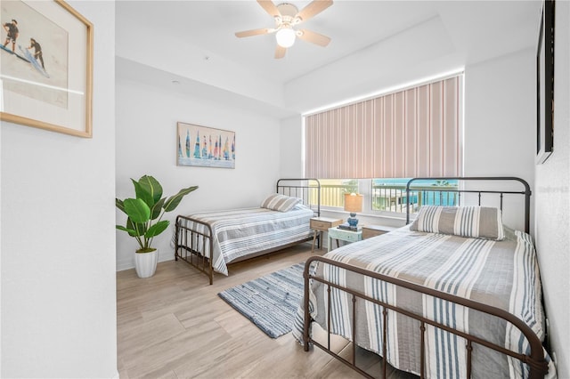 bedroom with light hardwood / wood-style flooring and ceiling fan