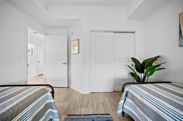 bedroom featuring a closet and light hardwood / wood-style floors