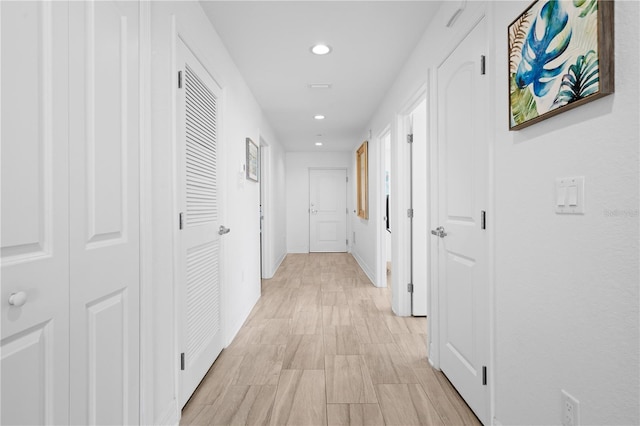 corridor with light hardwood / wood-style flooring