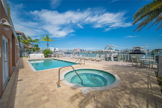 view of pool with a hot tub