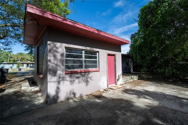 view of side of property featuring a patio area