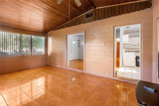 tiled spare room featuring washer / dryer, lofted ceiling, wood ceiling, and ceiling fan