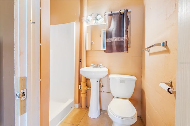 bathroom featuring tile patterned floors, sink, and toilet