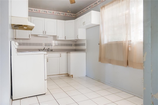 kitchen with white cabinetry, ceiling fan, stove, and backsplash